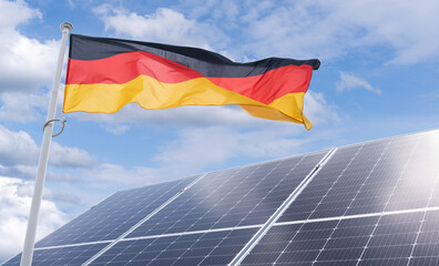 German flag flutters on the background of solar panels. Symbol of Sustainable development Federal...