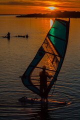 Windsurfing on the lake at sunset - 760825663