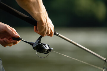 Close-up of a fisherman's hands with a fishing rod