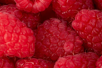 Raspberries. Fresh juicy raspberries bright background. Close-up.