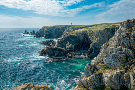 Lighthouse overlooking cliffs at sea at the coast during a dramatic day