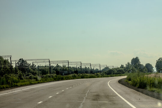 road to the city. track in the forest. industry and nature