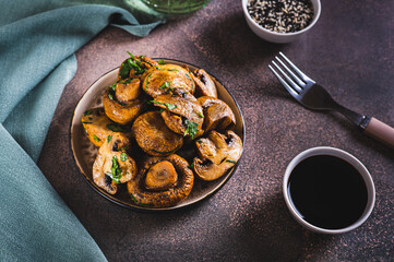 Homemade grilled mushrooms with herb on a plate on the table