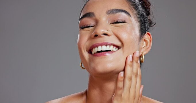 Face, beauty and laughing with smile of woman in studio on gray background for health, humor or wellness. Skincare, portrait and funny with happy young model proud of natural aesthetic or cosmetics