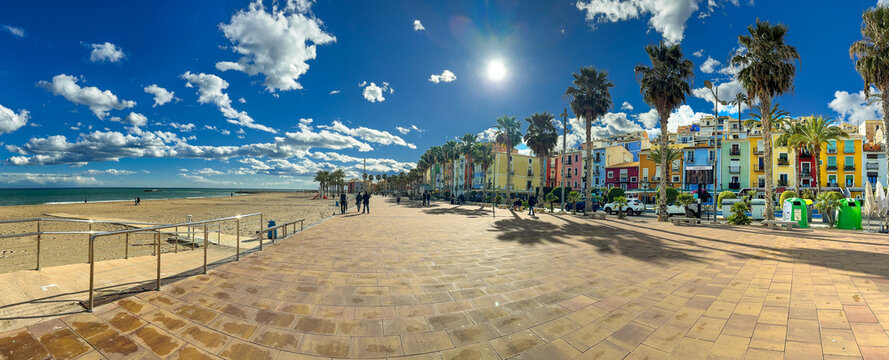 Panoramic view of Villajoyosa beach promenade with landmark colorful old town homes in a sunny day, on the Mediterranean coast of Spain.