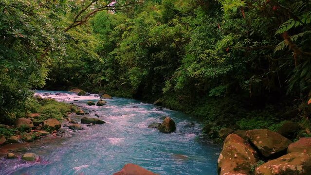 Close perspective of Rio Celeste, blue river in the jungle in Costa Rica, drone footage