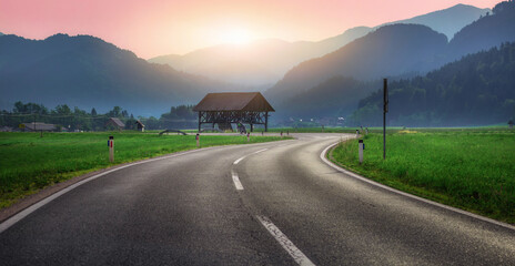 Highway in mountain village in summer evening, travel concept