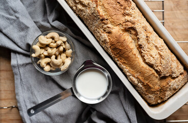 Homemade yeast cake in pan with crumble and hot milk for breakfast in the morning. Fresh home...