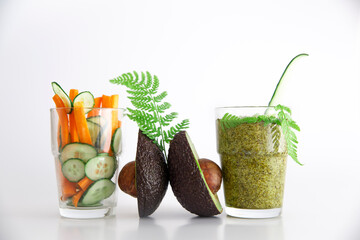 Still life of vegetables and drinks. Summer easy cooking. Smoothies and vegetables in a composition on a white background - obrazy, fototapety, plakaty