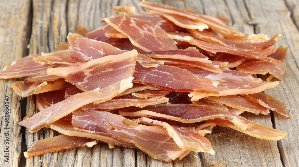 Poster a pile of sliced bacon sitting on top of a wooden table next to a slice of pizza on top of a plate.