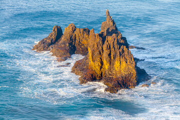 Aerial view of a rocky island in the sea