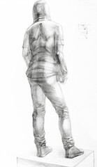 Fototapeta na wymiar educational drawing from back of male model dressed in hooded shirt and pants standing on podium drawn by hand with graphite pencil on white paper