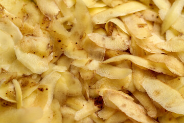 Heap of fresh potato peels. Peeled vegetable skin. Kitchen garbage.