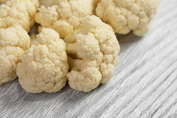 Fresh cauliflower on a wooden kitchen cutting board. Raw vegetable dietary ingredients