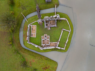 Aerial view of ancient castle ruins surrounded by moat