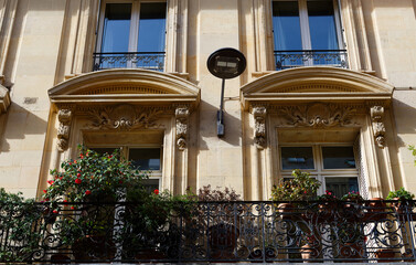The facade of traditional French house with typical balconies and windows. Paris. - 760853013