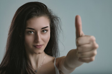 Radiant optimism in her triumphant thumbs-up