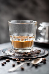 Vietnamese coffee with milk in a glass, coffee beans on a dark background - 760856465