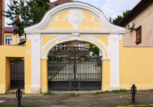 uzhgorod, ukraine - 28 jun 2016: transcarpathia academy of arts entrance with gate in renaissance style. architectural background