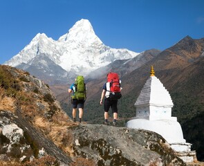 Mount Ama Dablam white Stupa and two hikers