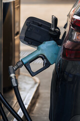 fuel pump filling gasoline or gasoline in vehicle with rising prices according to the economy