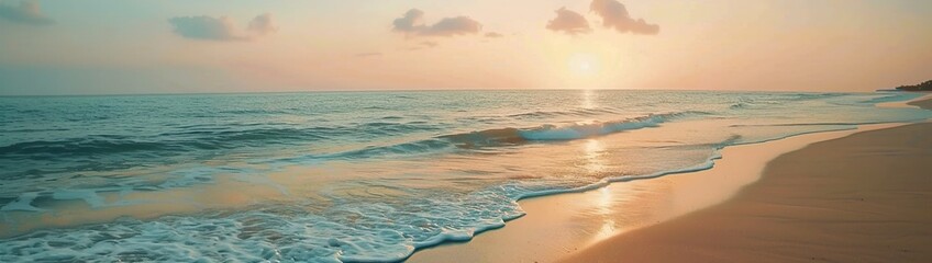 A tranquil beach at sunrise, with gentle waves lapping against the shore under a pastel sky.