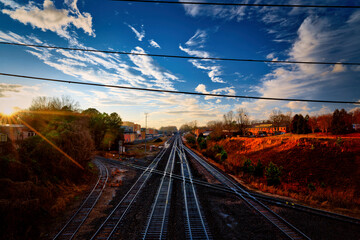 Urban railroad tracks going towards the horizon at sunset in Raleigh, North Carolina.
