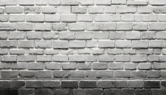 A brick wall with a black and white background as a background, template, banner or page.. The wall is made of white bricks and has a greyish color