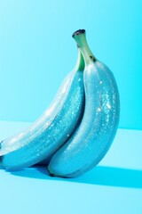 Sparkling Bananas: Glitter-Covered Fruit on a Cool Blue Background