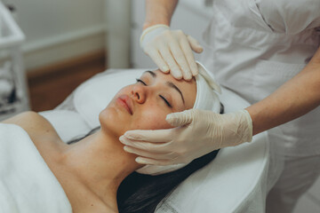 girl at a cosmetologist's office doing skin cleansing