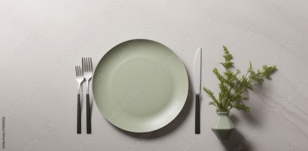 Wall mural Minimalistic table setting in neutral green color on gray concrete background, perfect for modern kitchens and Scandinavian-style tableware. Suitable for business food brand