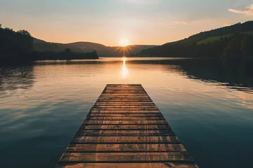Zelfklevend Fotobehang Golden hour over a serene lake with a single wooden pier Evoking feelings of peace and solitude perfect for contemplative or nature-inspired imagery © Lucija
