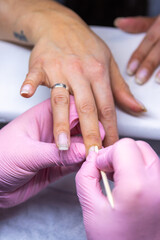 Obraz na płótnie Canvas Close-up of meticulous nail filing in progress