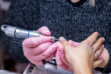 Manicure process with electric nail file in action