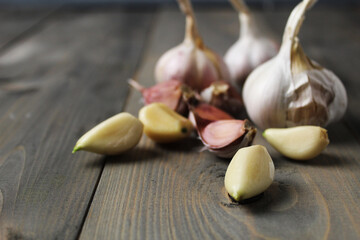 Peeled garlic cloves on gray background close-up. Spicy ingredients in cooking. Garlic as a condiment