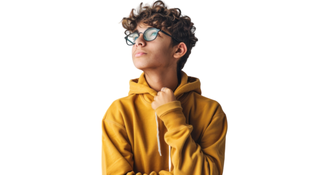 A young man with curly hair exudes joy in a yellow hoodie