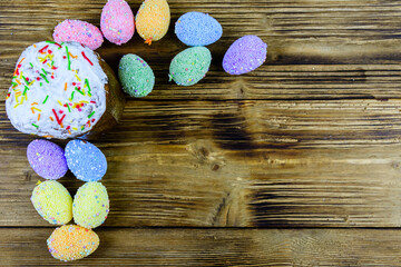 Traditional easter bread and easter eggs made of styrofoam on a wooden background. Top view