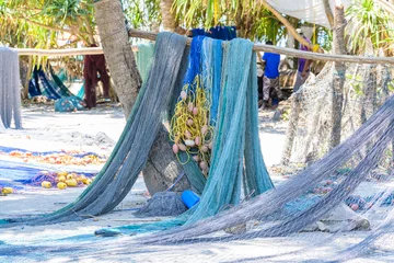 Fotobehang Fishing nets drying near the beach in Nungwi village, Zanzibar © ihorbondarenko