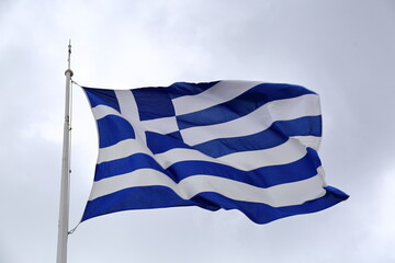 greek flag waving against sky