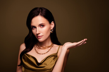 Portrait of stunning wealthy lade femme fatal introduce jewellery shop empty space on brown...