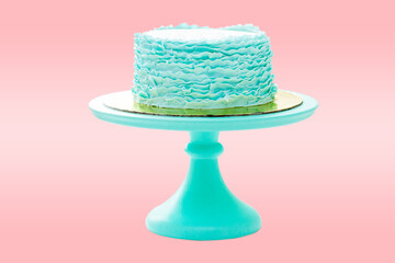 Green elegant birthday cake with fondant ruffles isolated on background with copy space for text