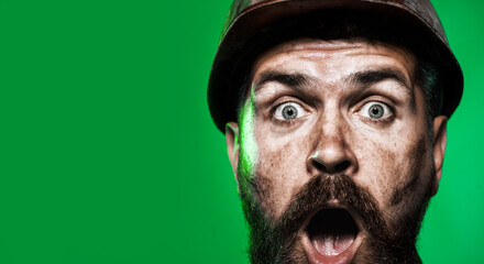 Closeup portrait surprised construction worker in hard hat. Amazed bearded industrial worker in...