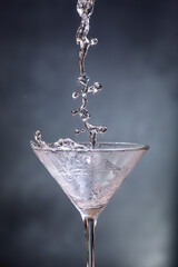 Pouring chilled gin into a martini glass