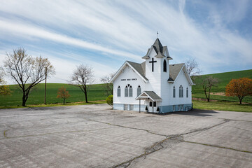 A small white church with a cross on top