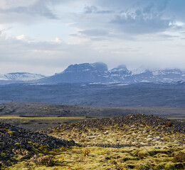 Iceland autumn tundra landscape near Haoldukvisl glacier, Iceland. Glacier tongue slides from the...
