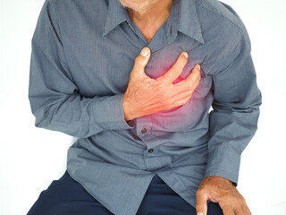 Asian man having severe chest pain as heart attack and illness concept on white background. closeup photo, blurred.
