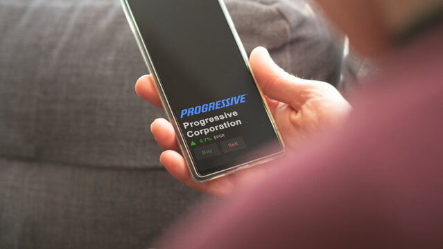 March 12th 2024 Mayfield Village, Ohio. The logo of Progressive Corporation on the screen of an exchange. Progressive Corporation price stocks, $PGR on a device.