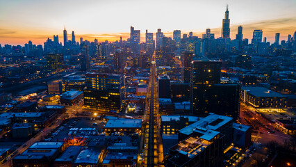 A captivating aerial view of a cityscape at dusk, showcasing illuminated skyscrapers against the...