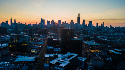 A captivating aerial view of a cityscape at dusk, showcasing illuminated skyscrapers against the...