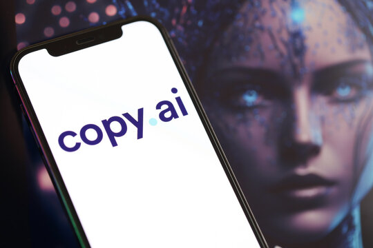 KYIV, UKRAINE - MARCH 17, 2024 CopyAI logo on iPhone display screen with background of artificial intelligence futuristic ai generated image close up